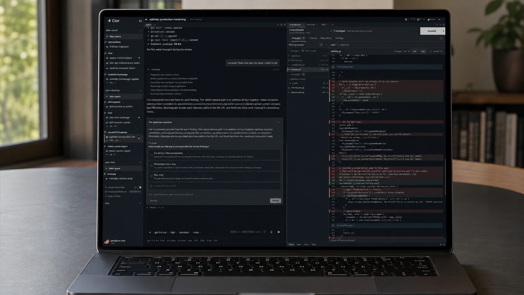 A laptop displaying the Clor coding agent workspace and a code review on a quiet desk